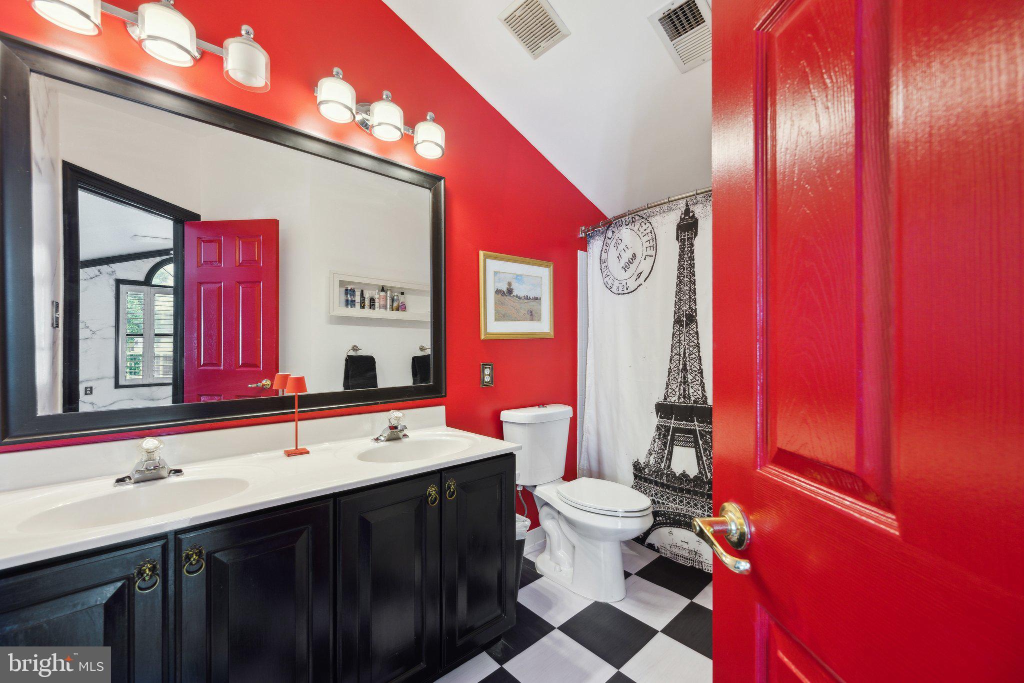 304 Thompson Dairy Way Rockville, MD 20850 - Photo 27 of 42 a bathroom with a sink a toilet a mirror and vanity