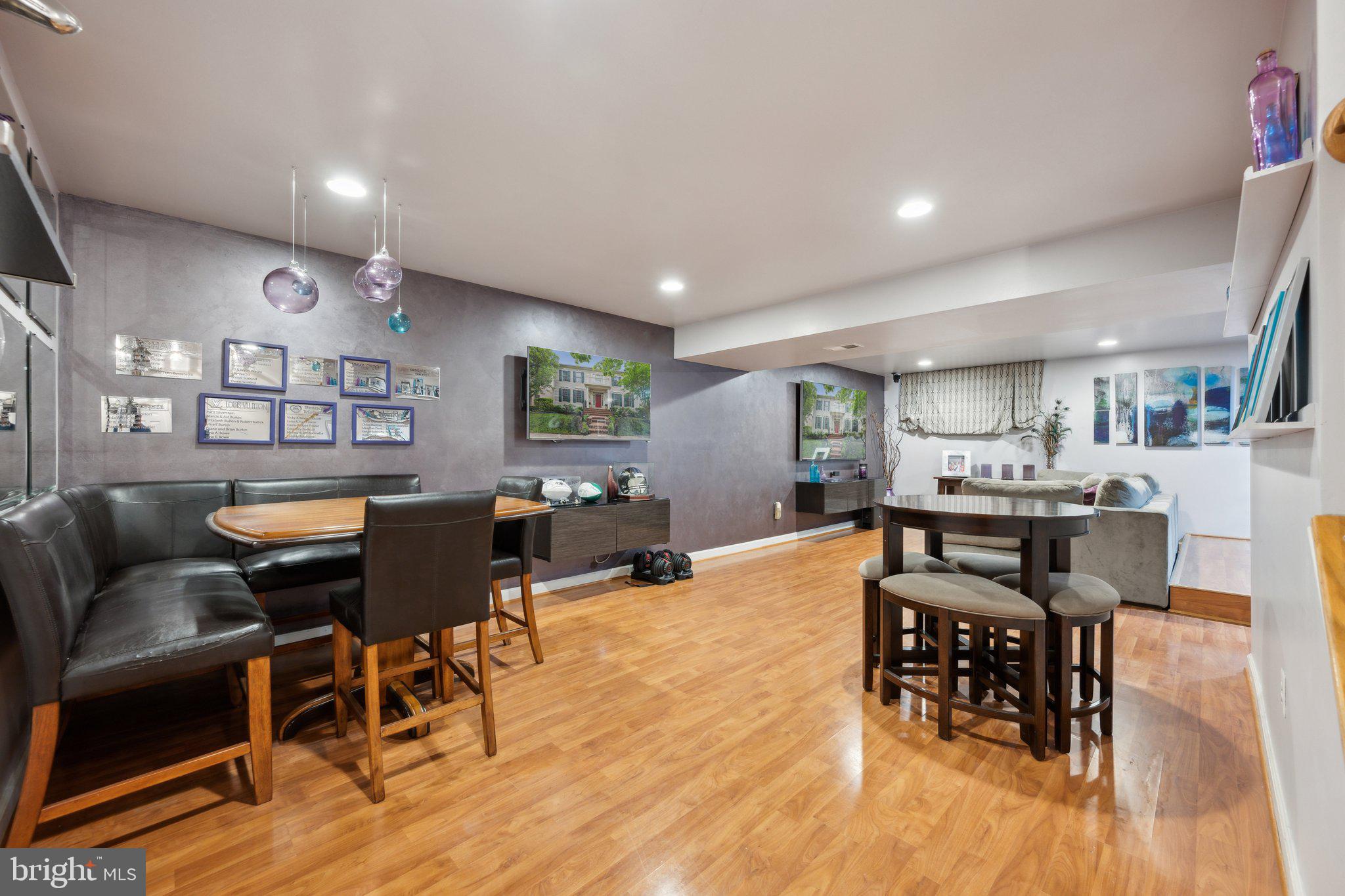 304 Thompson Dairy Way Rockville, MD 20850 - Photo 28 of 42 a living room with furniture kitchen view and a wooden floor