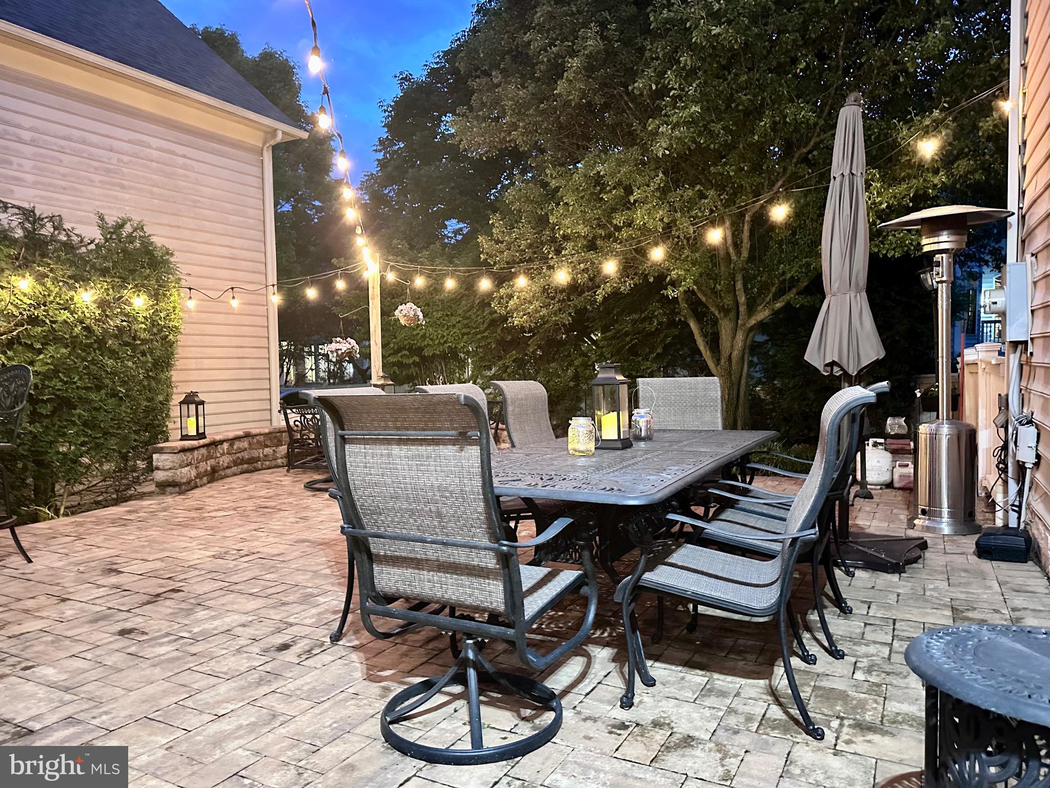 304 Thompson Dairy Way Rockville, MD 20850 - Photo 34 of 42 a view of a patio with table and chairs and potted plants
