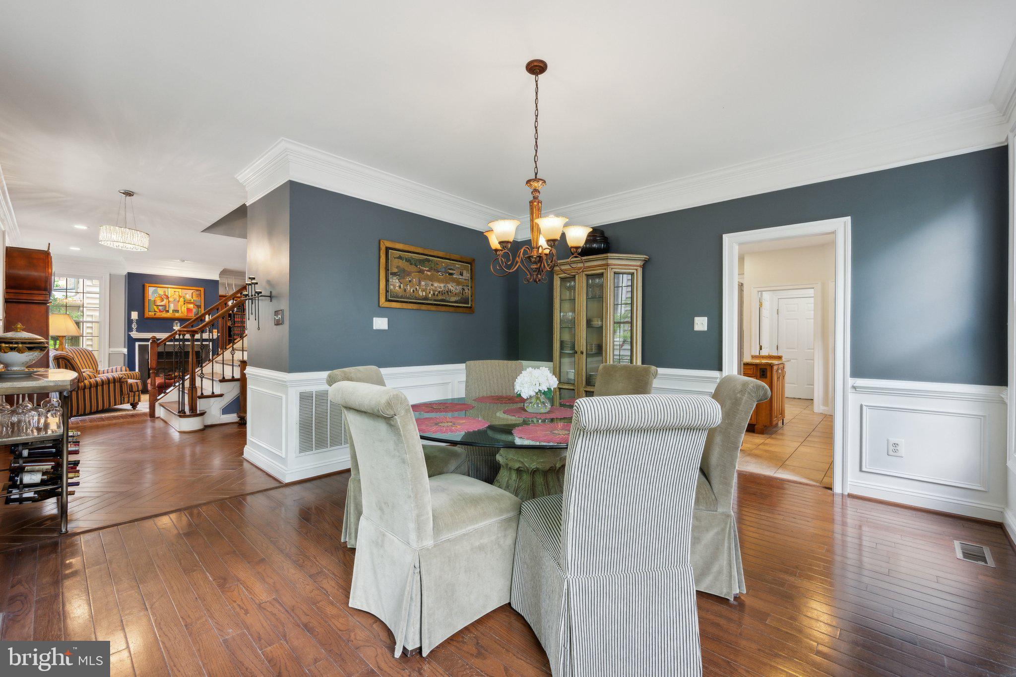 304 Thompson Dairy Way Rockville, MD 20850 - Photo 4 of 42 a living room with furniture a chandelier and a wooden floor