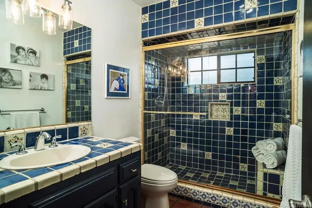 a bathroom with a sink toilet and shower