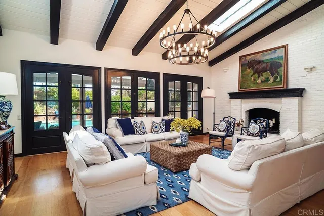 a living room with furniture large window and fireplace
