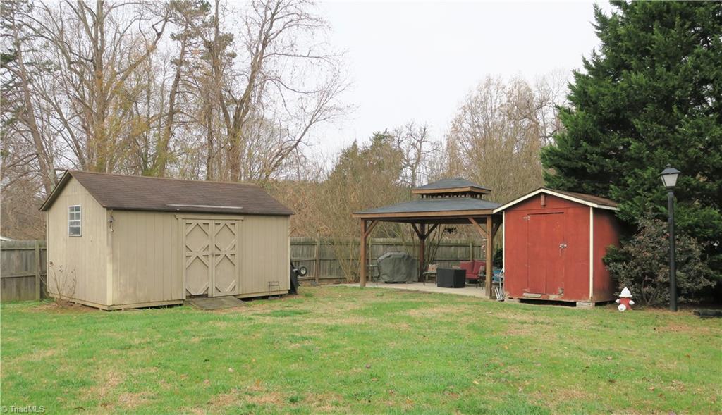 702 Rapp Street Thomasville, NC 27360 - Photo 8 of 30 Includes 8FT X 12FT and 12FT X 16FT Storage buildings and 12FT X 16FT Gazebo! Fire hydrant beside red building is non-working and for decoration only. Owners are taking that with them.