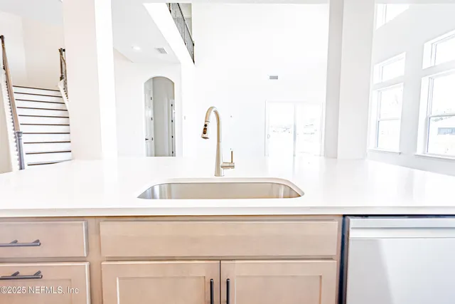 a stove top oven sitting inside of a kitchen