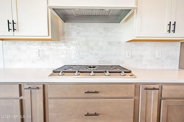 a view of a kitchen with stainless steel appliances cabinets