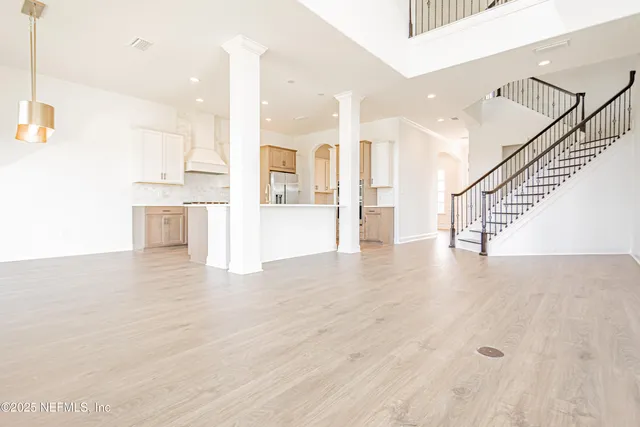 a view of a kitchen with wooden floor and a sink
