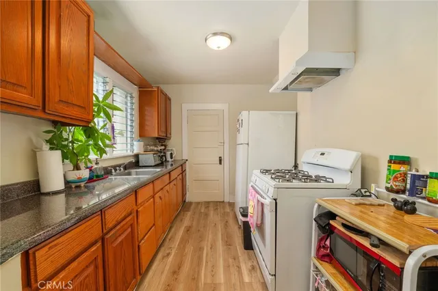 a large white kitchen with a large window