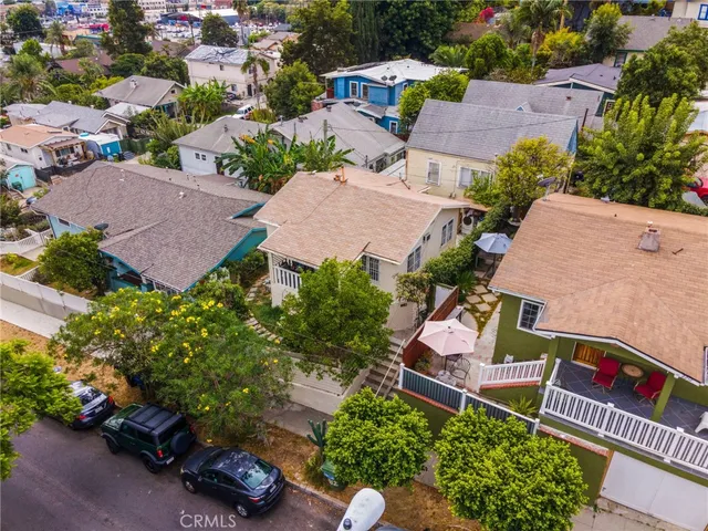 an aerial view of a house with garden space and street view