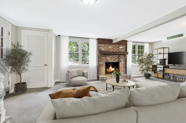 a living room with furniture and a fireplace