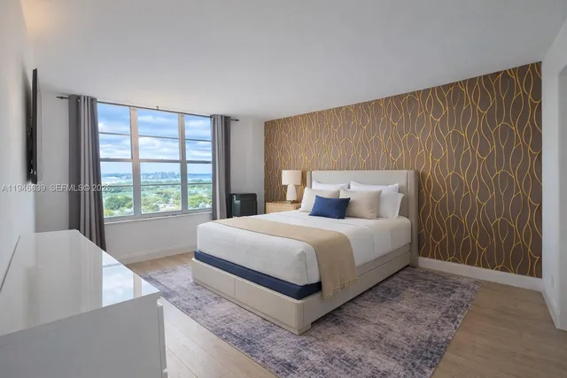 a bedroom with a bed and a large window