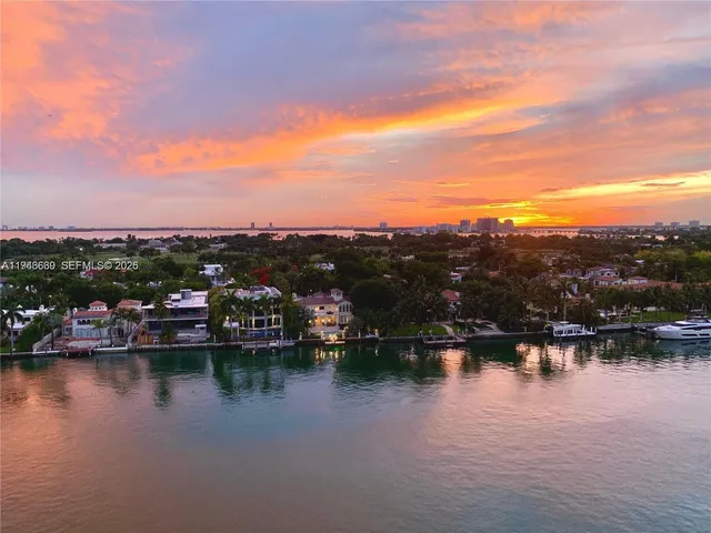 a view of residential houses with outdoor space and lake