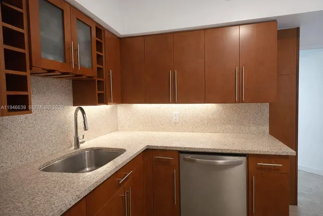 a kitchen with a sink and cabinets
