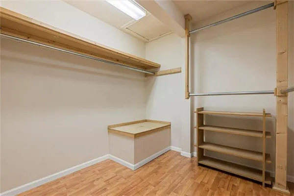 a view of walk in closet with empty racks