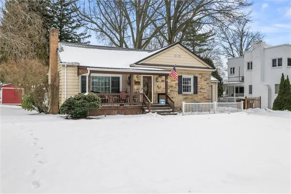 a front view of a house with a yard outdoor seating and garage