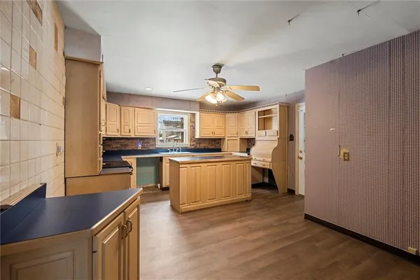 a kitchen with a sink appliances cabinets and a counter top space