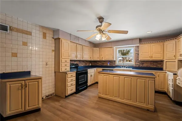 a kitchen with stainless steel appliances a stove sink and microwave