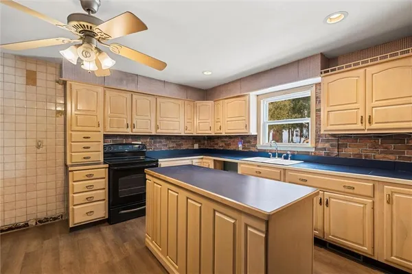 a kitchen with stainless steel appliances granite countertop a sink and a stove