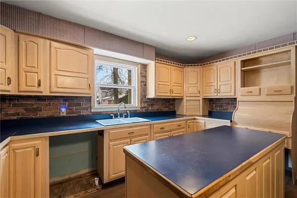a kitchen with stainless steel appliances granite countertop a sink and a microwave