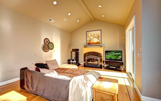 a spacious bedroom with a bed and a fireplace