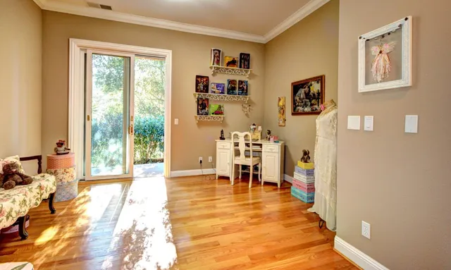 a view of a livingroom with furniture wooden floor and windows
