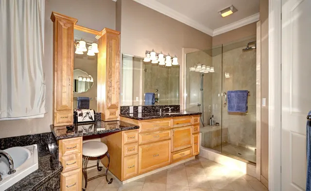 a large bathroom with a tub sink and mirror
