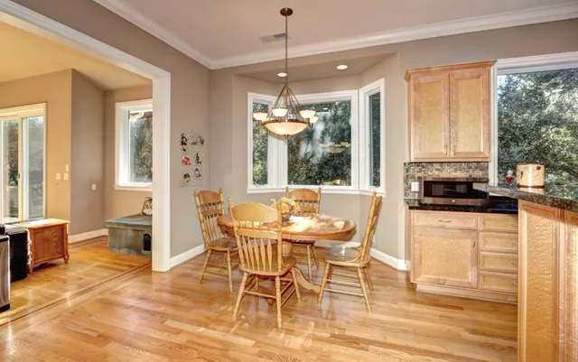 a dining room with furniture a chandelier and wooden floor