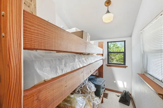 a view of a balcony with furniture and wooden floor