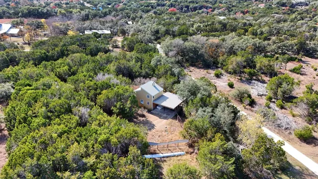 an aerial view of house with yard and outdoor seating