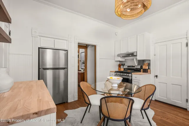 a view of a house with brick walls and a yard with plants