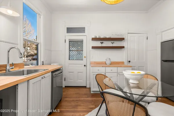a front view of a house with a garden and plants