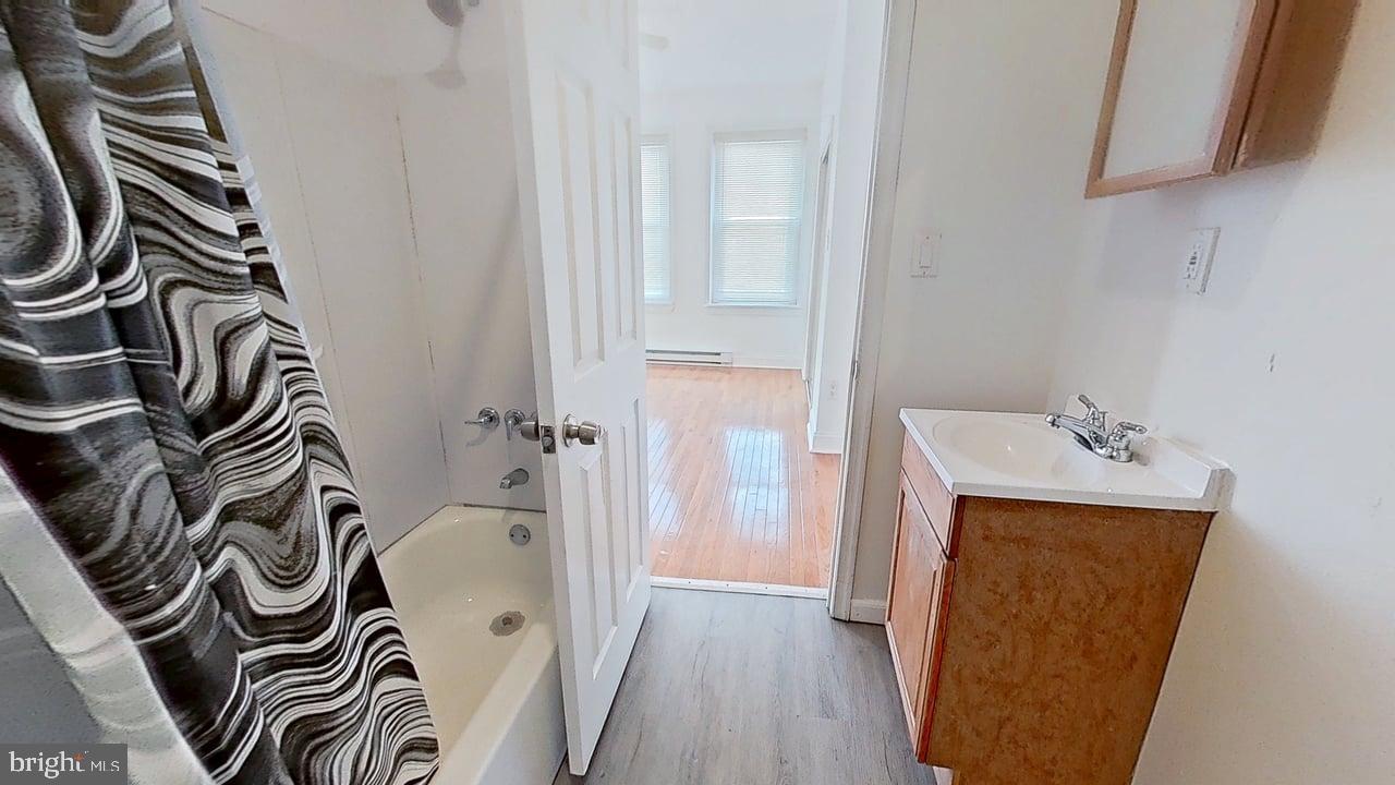 1234-40 Rising Sun Avenue, Unit D Philadelphia, PA 19140 - Photo 11 of 11 a bathroom with a sink a toilet and a mirror