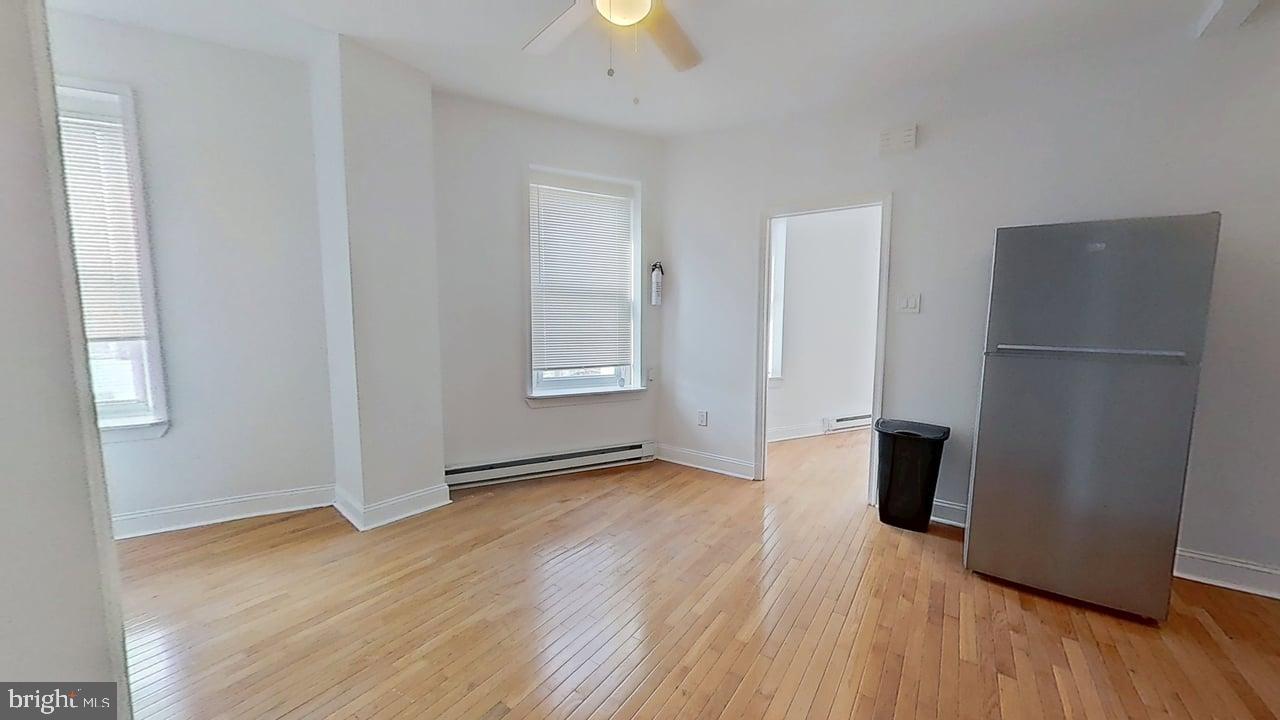 1234-40 Rising Sun Avenue, Unit D Philadelphia, PA 19140 - Photo 2 of 11 an empty room with wooden floor and a window