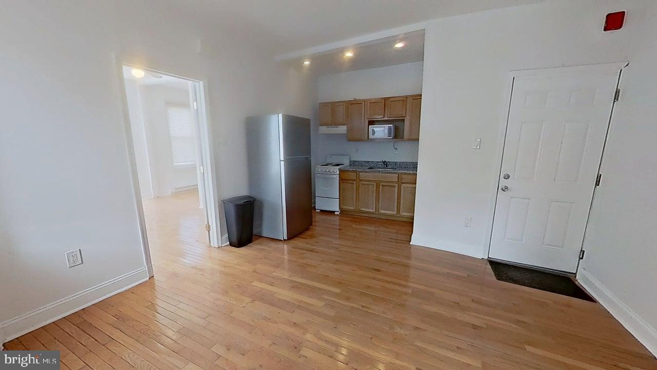 1234-40 Rising Sun Avenue, Unit D Philadelphia, PA 19140 - Photo 3 of 11 a view of a kitchen with a refrigerator and a stove