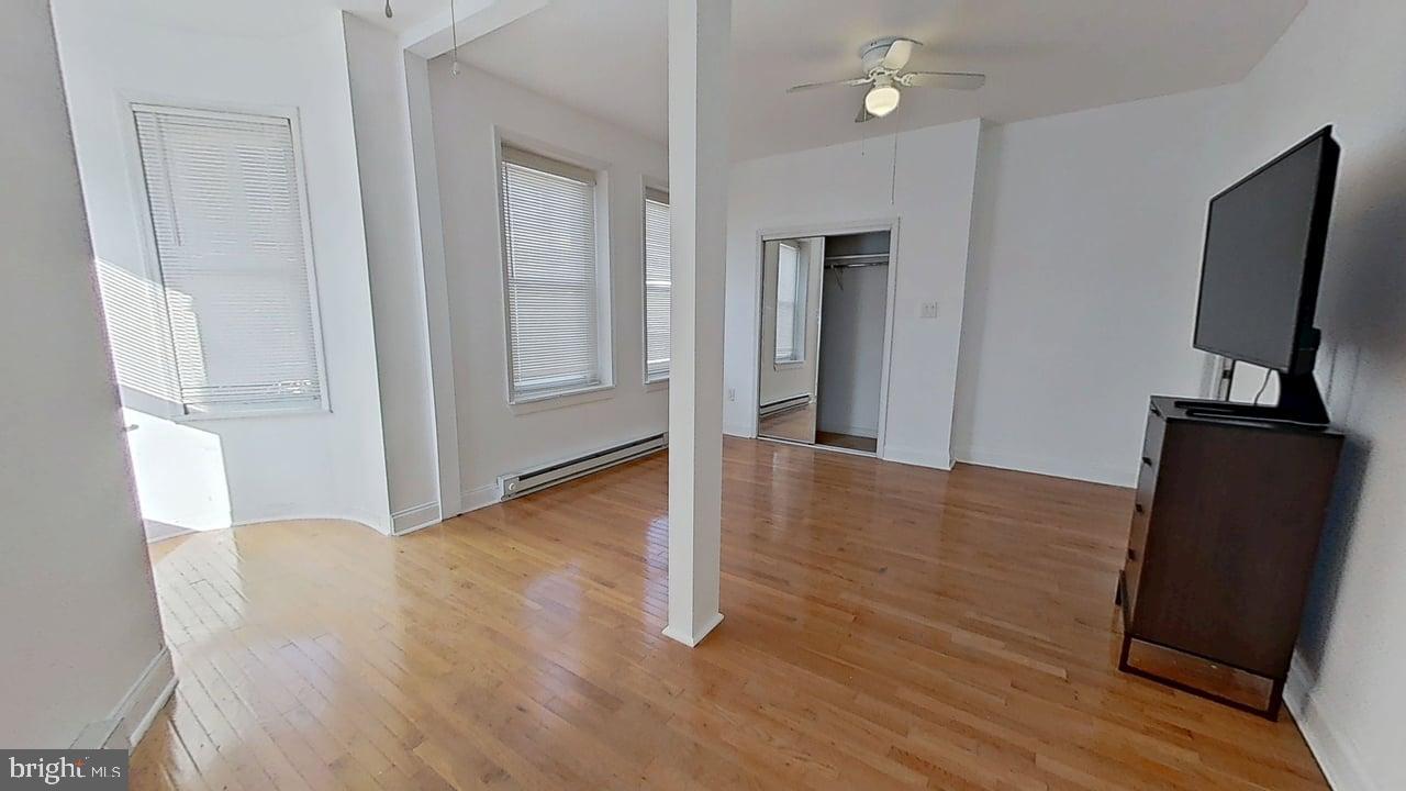 1234-40 Rising Sun Avenue, Unit D Philadelphia, PA 19140 - Photo 6 of 11 wooden floor in an empty room with a window