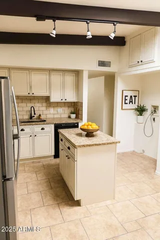 a kitchen with stainless steel appliances granite countertop a sink and cabinets