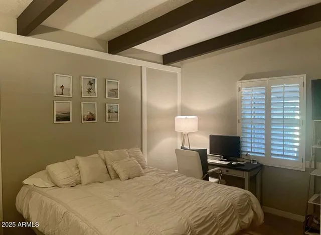 a bedroom with a bed and a lamp
