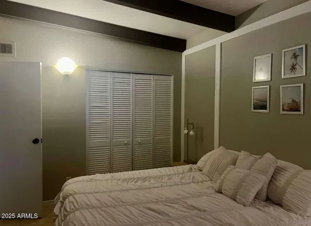 a bedroom with a bed and a shower