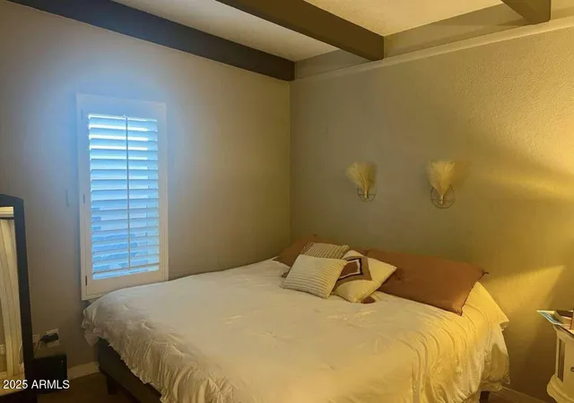 a bedroom with a bed and a window