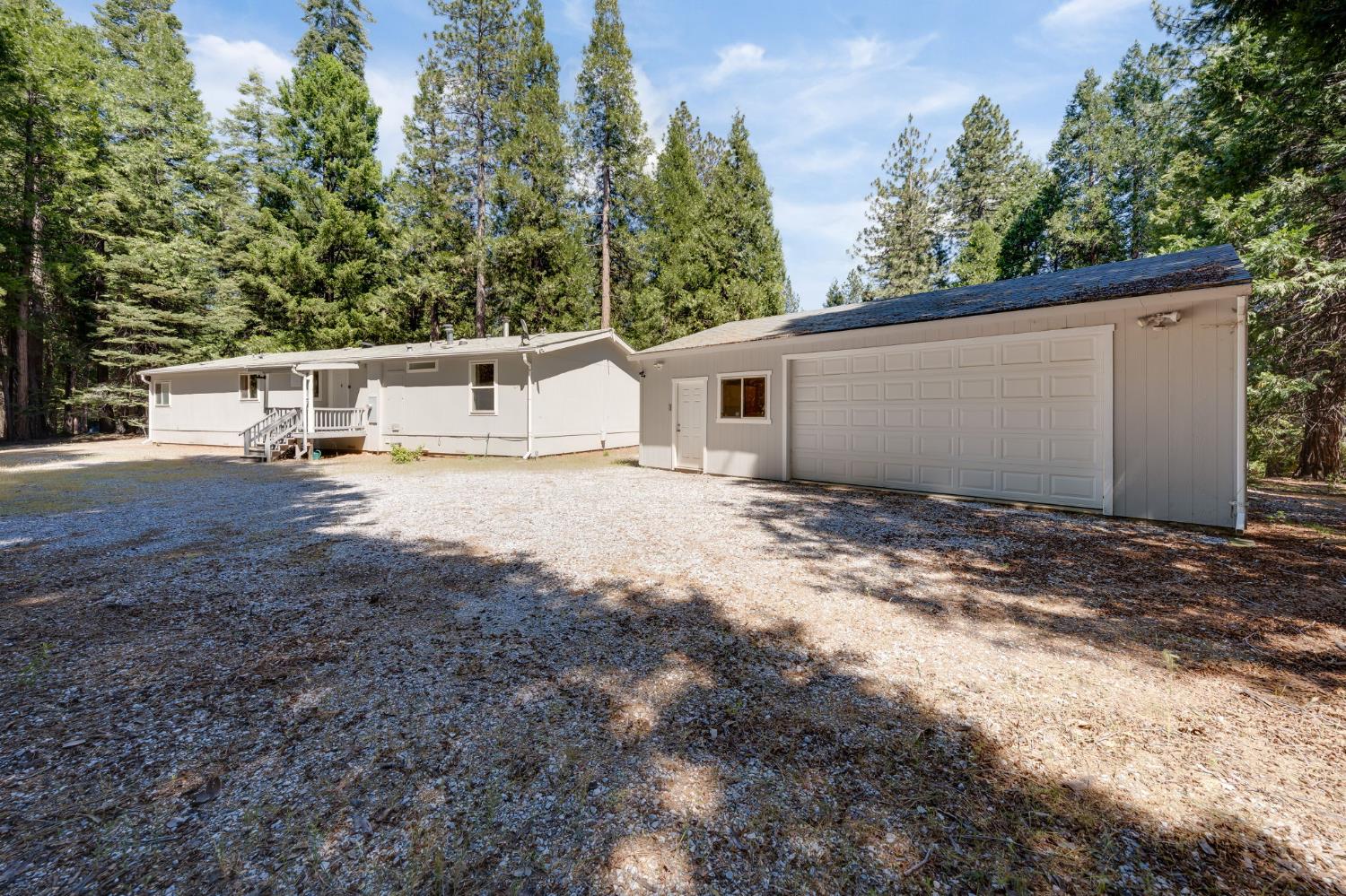 28722 Wood Road Pioneer, CA 95666 - Photo 6 of 39 a view of a white house with a yard and sitting area