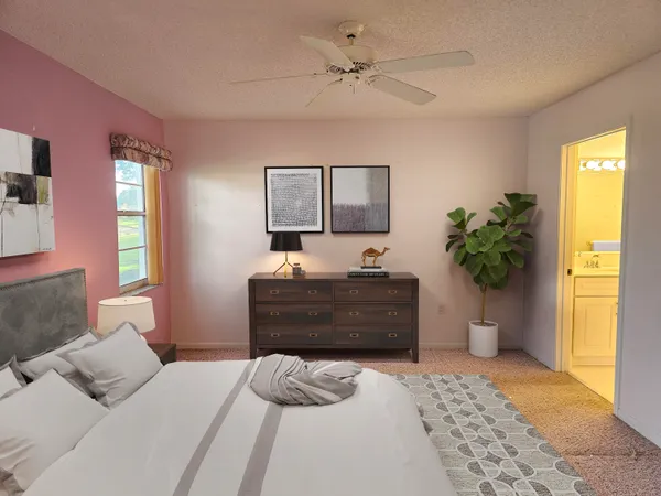 a bedroom with a bed potted plant and a window