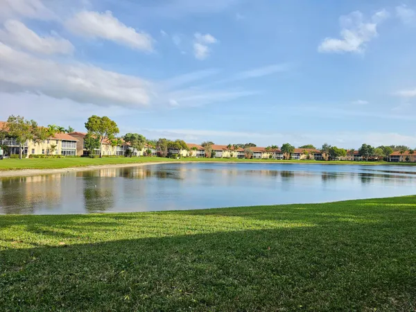 a view of a lake with houses in the back