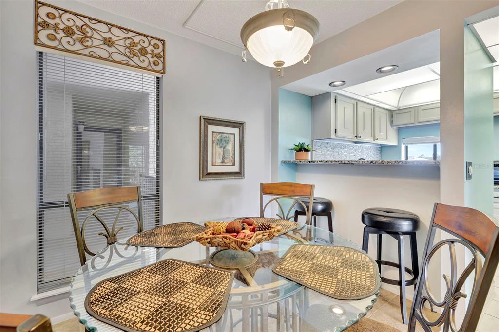 6157 Midnight Pass Road, Unit E24 Sarasota, FL 34242 - Photo 19 of 44 a bedroom with furniture and a wooden floor