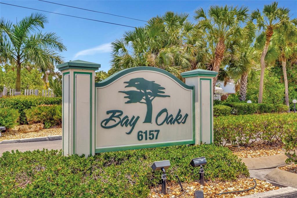 6157 Midnight Pass Road, Unit E24 Sarasota, FL 34242 - Photo 2 of 44 a sign on the side of the road