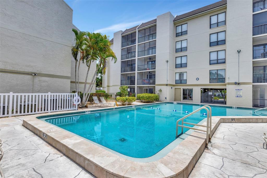 6157 Midnight Pass Road, Unit E24 Sarasota, FL 34242 - Photo 25 of 44 a view of swimming pool with outdoor seating