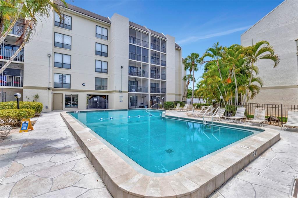 6157 Midnight Pass Road, Unit E24 Sarasota, FL 34242 - Photo 26 of 44 a view of swimming pool with outdoor seating