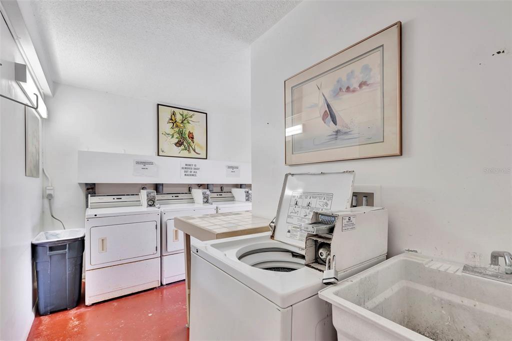 6157 Midnight Pass Road, Unit E24 Sarasota, FL 34242 - Photo 27 of 44 a kitchen with a sink stove and cabinets