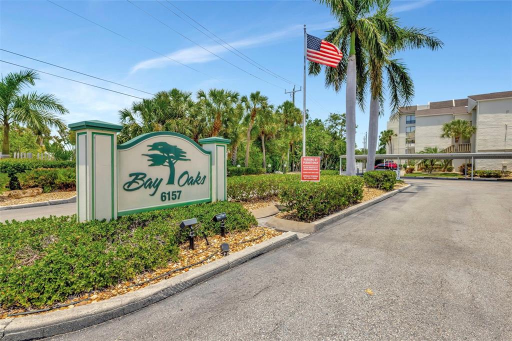 6157 Midnight Pass Road, Unit E24 Sarasota, FL 34242 - Photo 33 of 44 a view of a street with potted plants