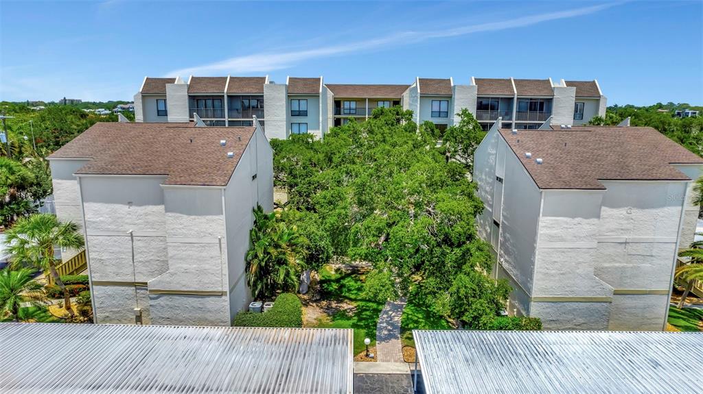 6157 Midnight Pass Road, Unit E24 Sarasota, FL 34242 - Photo 37 of 44 front view of a house with a yard