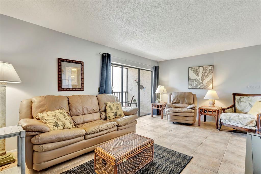 6157 Midnight Pass Road, Unit E24 Sarasota, FL 34242 - Photo 5 of 44 a living room with furniture or couch and two lamps