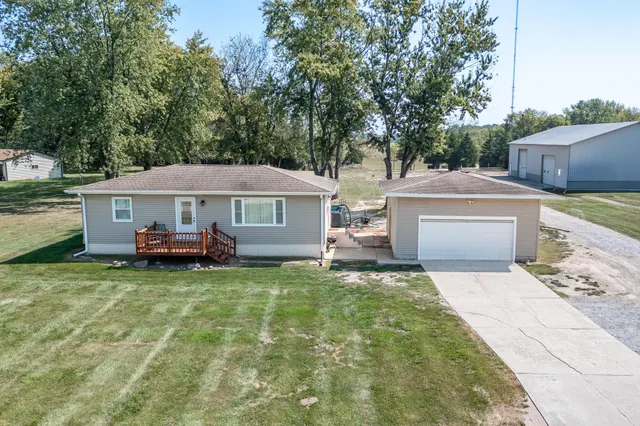 a front view of a house with a garden and trees